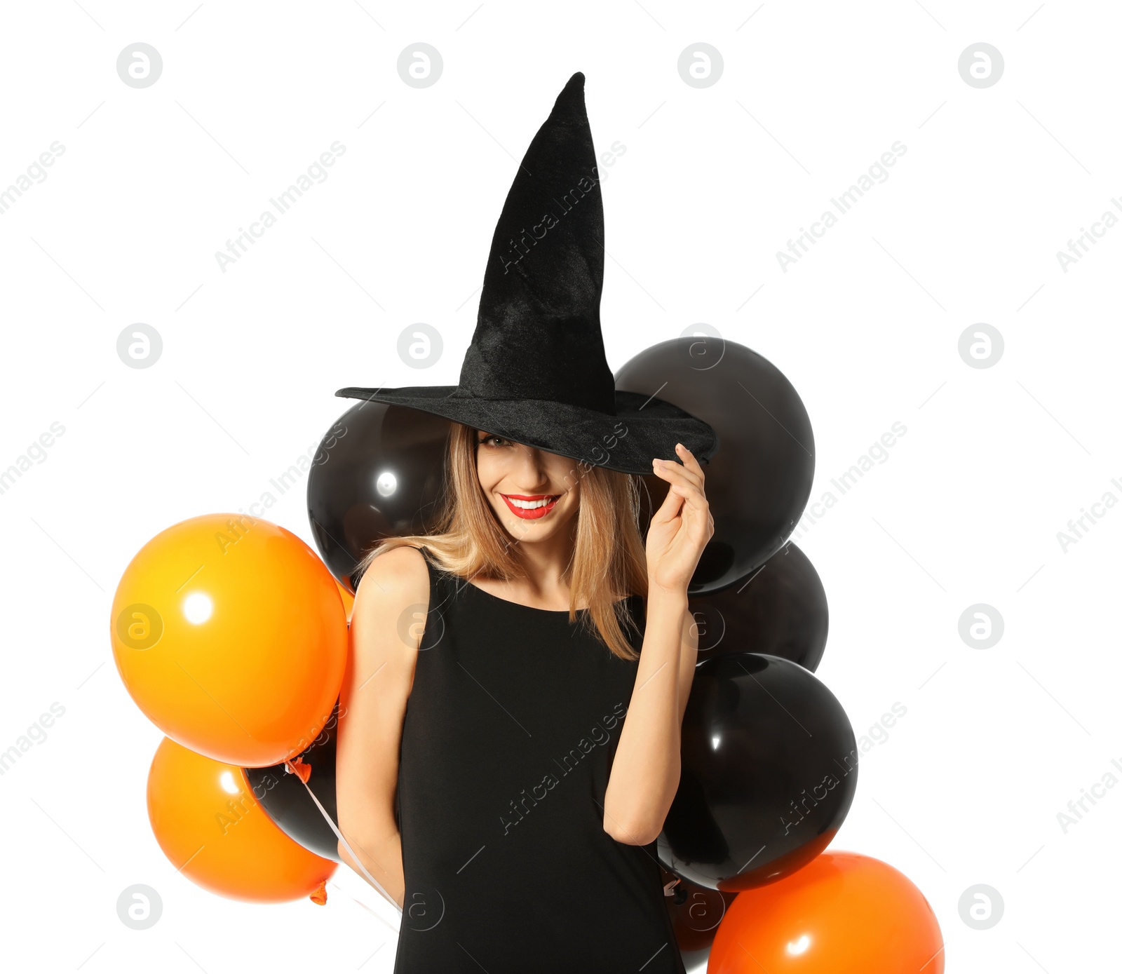 Photo of Beautiful woman wearing witch costume with balloons for Halloween party on white background