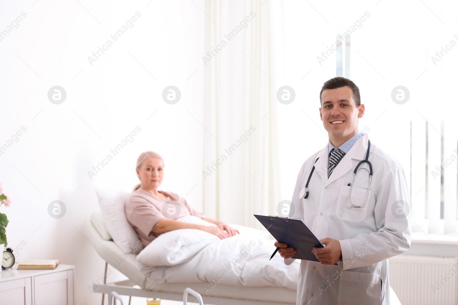 Photo of Doctor visiting his patient in hospital ward