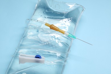 Photo of IV infusion set on light blue background, closeup