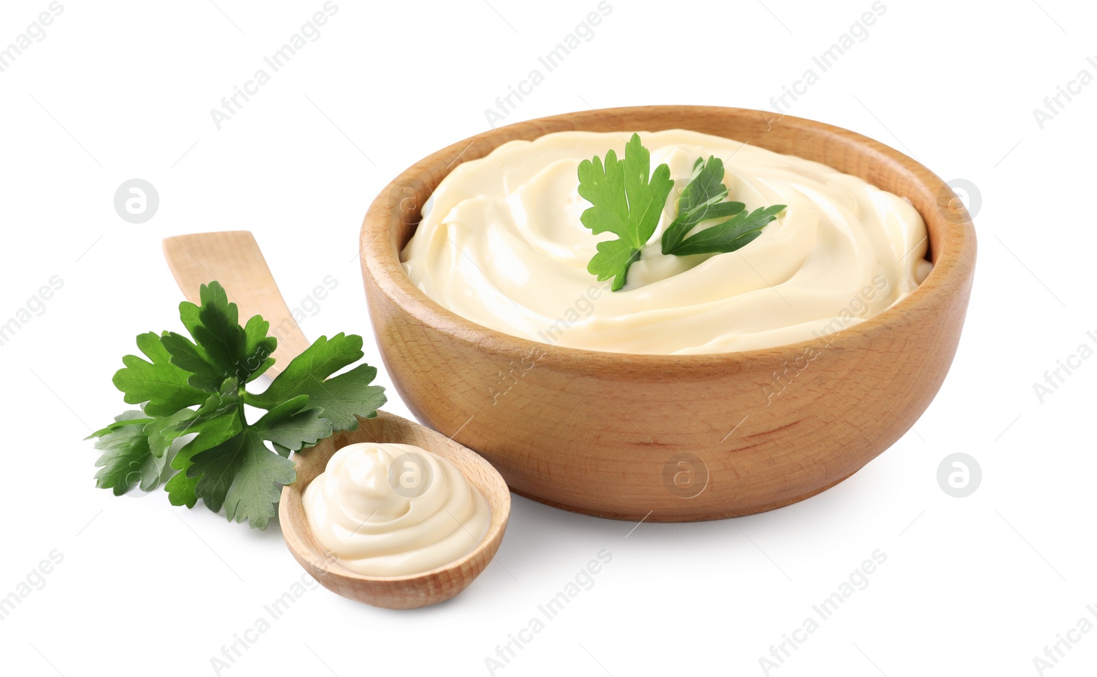 Photo of Spoon and bowl of delicious mayonnaise with parsley on white background