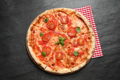 Photo of Delicious pizza Margherita on dark grey table, top view