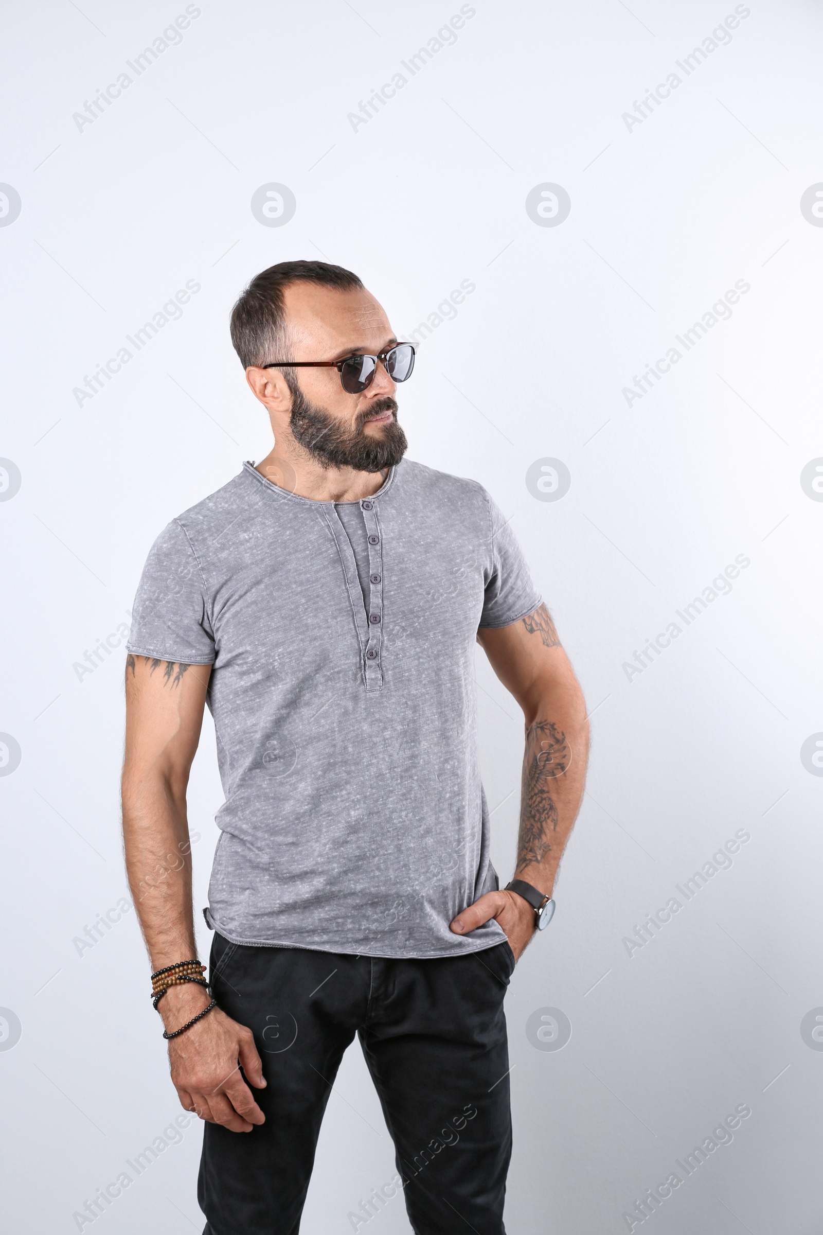 Photo of Portrait of handsome tattooed man on white background