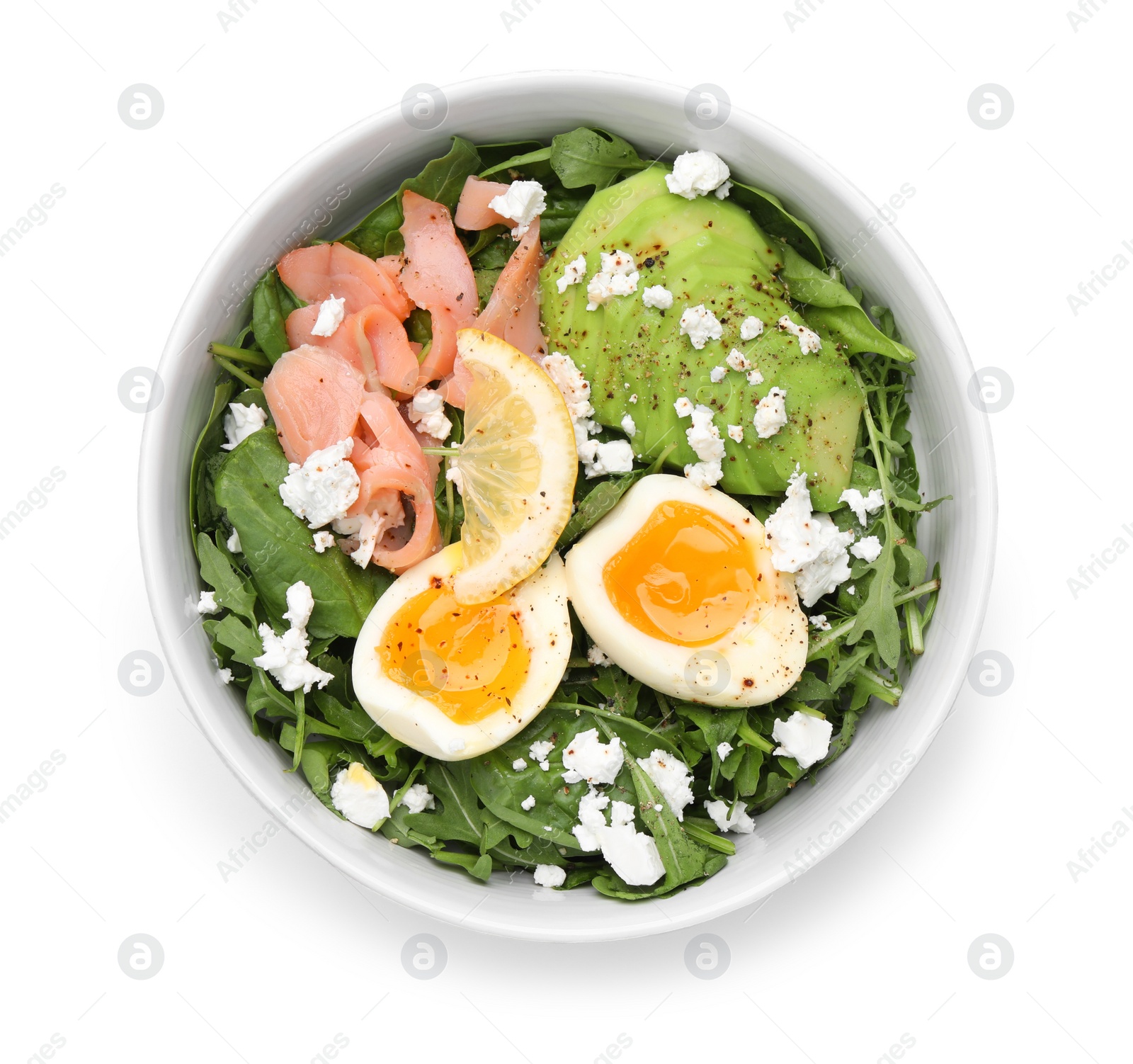 Photo of Delicious salad with boiled egg, salmon and cheese in bowl isolated on white, top view