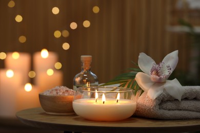 Composition with different spa products and orchid flower on wooden table