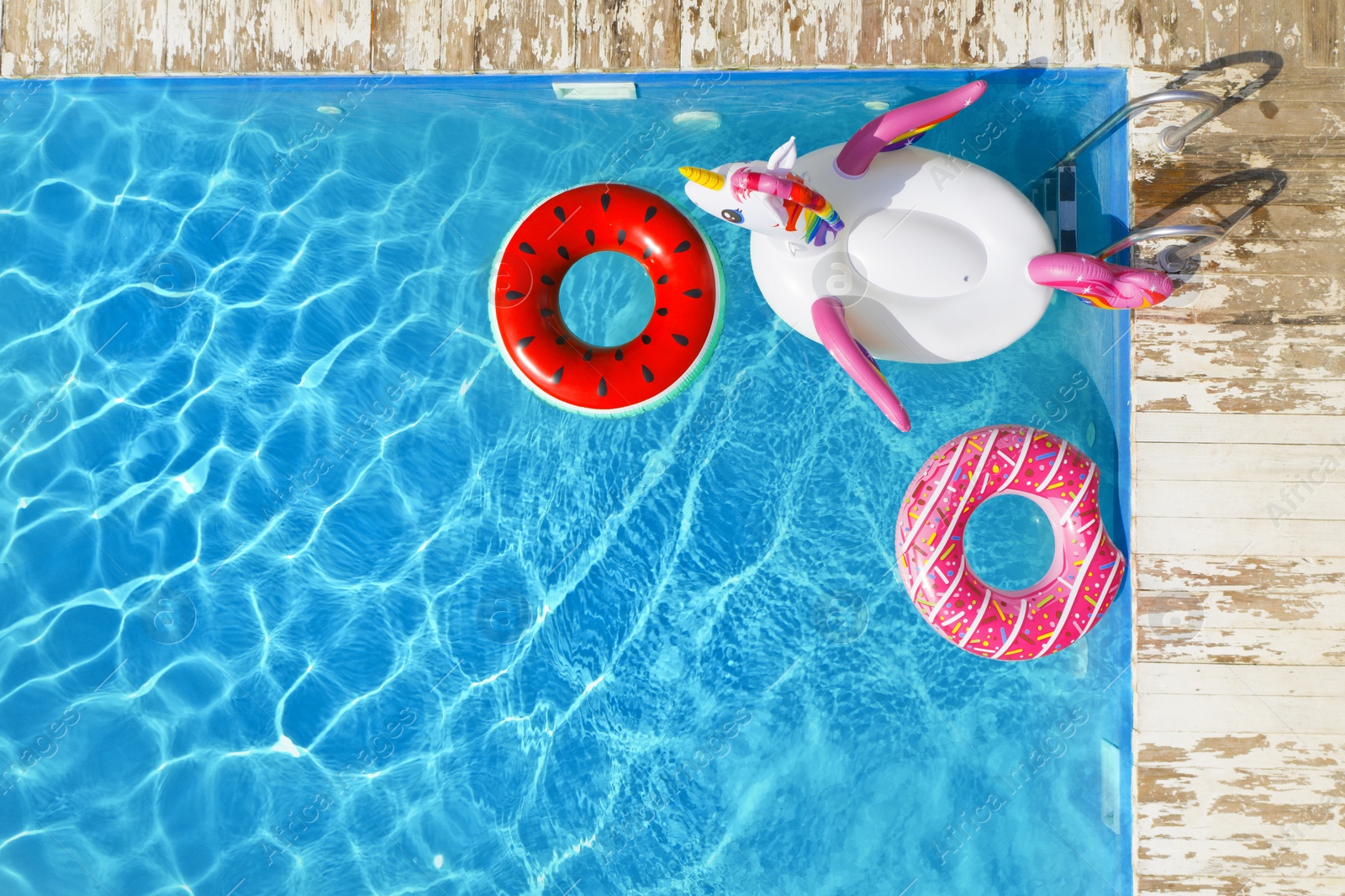 Image of Swimming pool with inflatable rings, top view