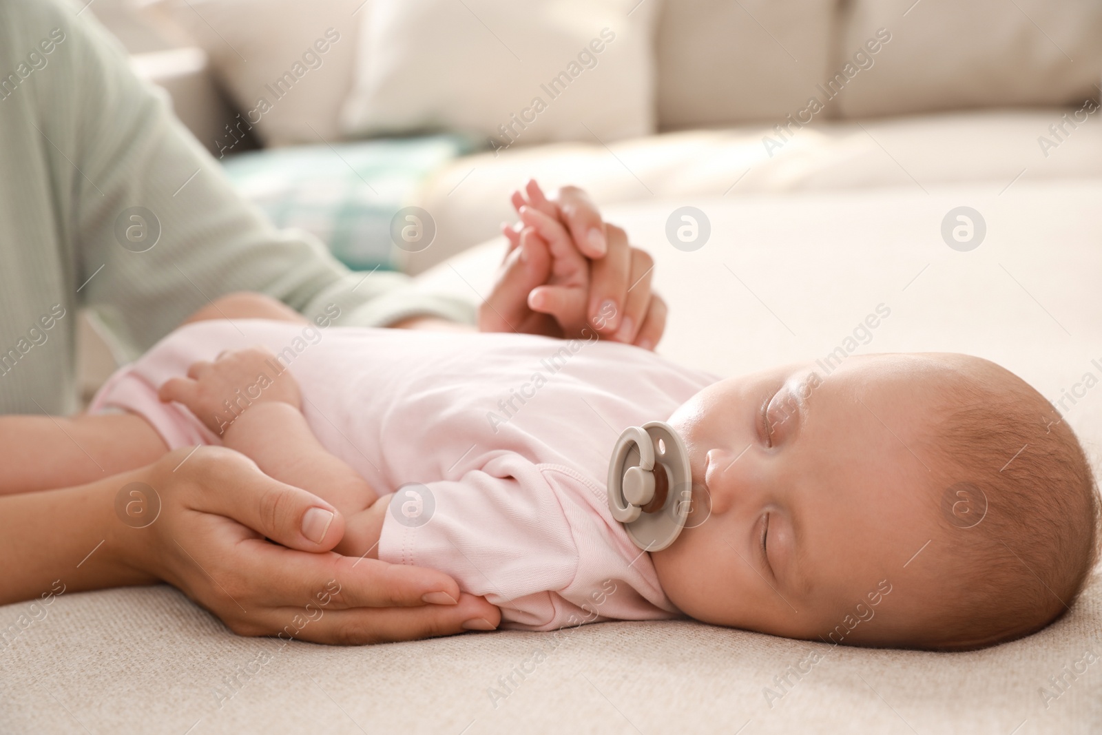 Photo of Mother with her cute sleeping baby at home, closeup