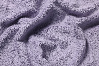 Photo of Texture of soft violet crumpled fabric as background, top view