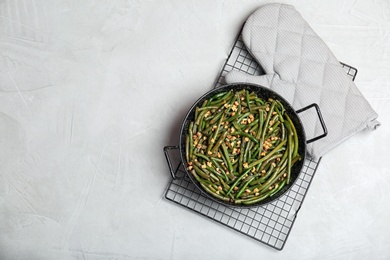 Yummy green beans with almonds in dish on table