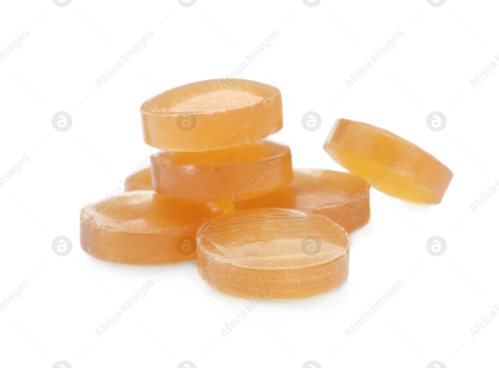 Photo of Many yellow cough drops on white background