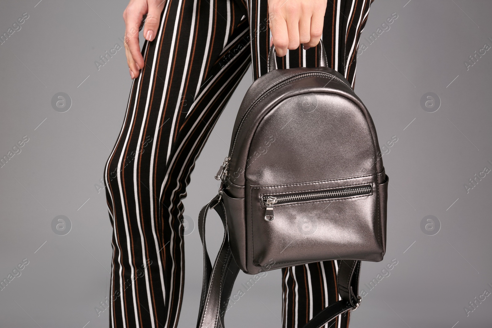 Photo of Woman with stylish backpack on grey background