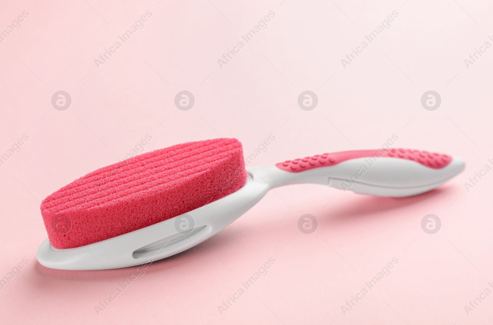 Photo of Pumice stone on pink background. Pedicure tool