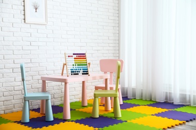 Photo of Stylish playroom interior with toys and modern furniture. Space for design