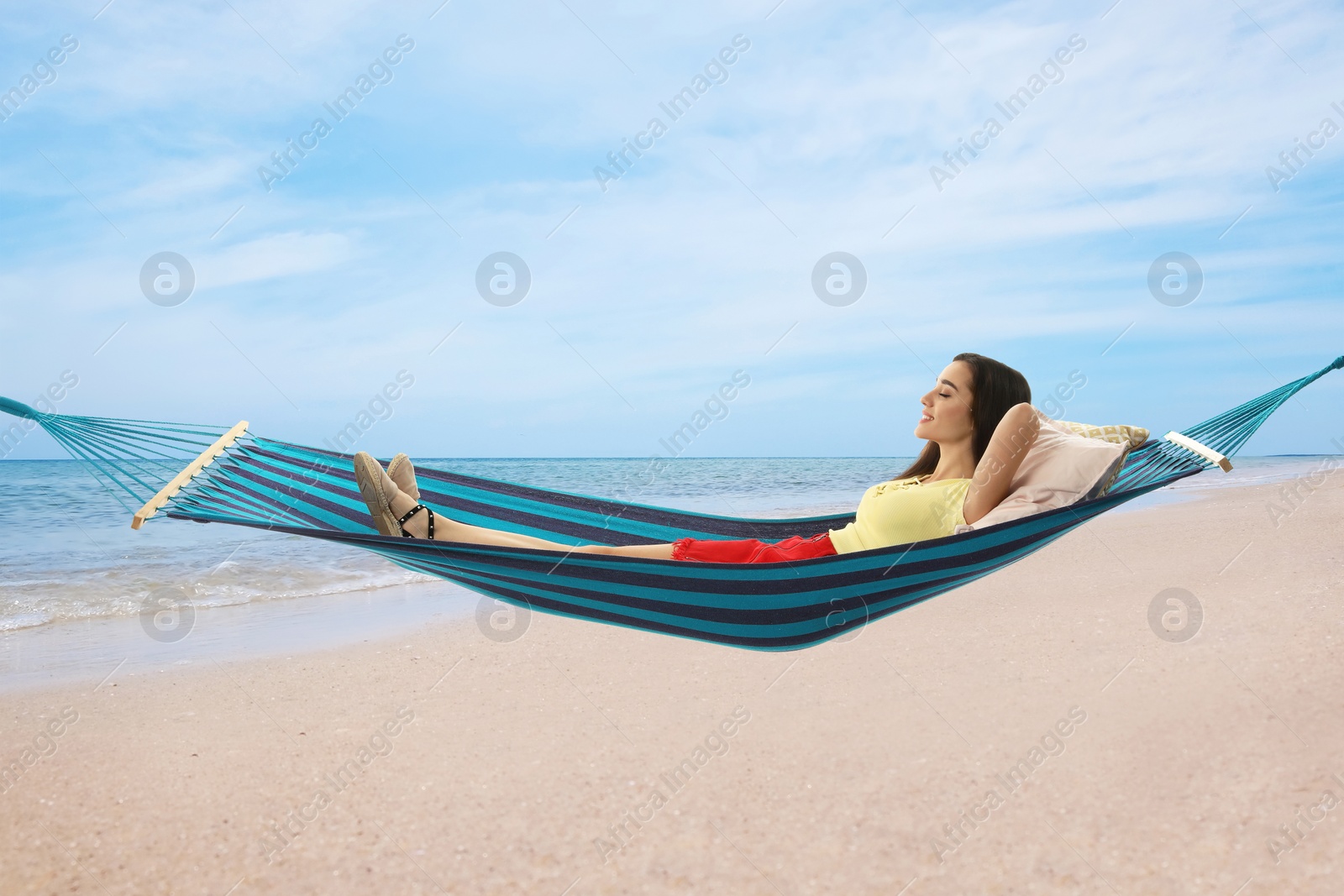 Image of Woman resting in hammock near sea on sunny day 
