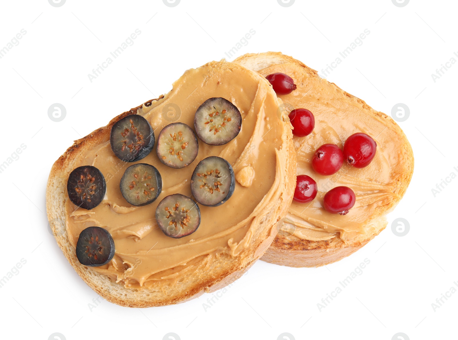 Photo of Slices of bread with peanut butter and berries on white background, top view