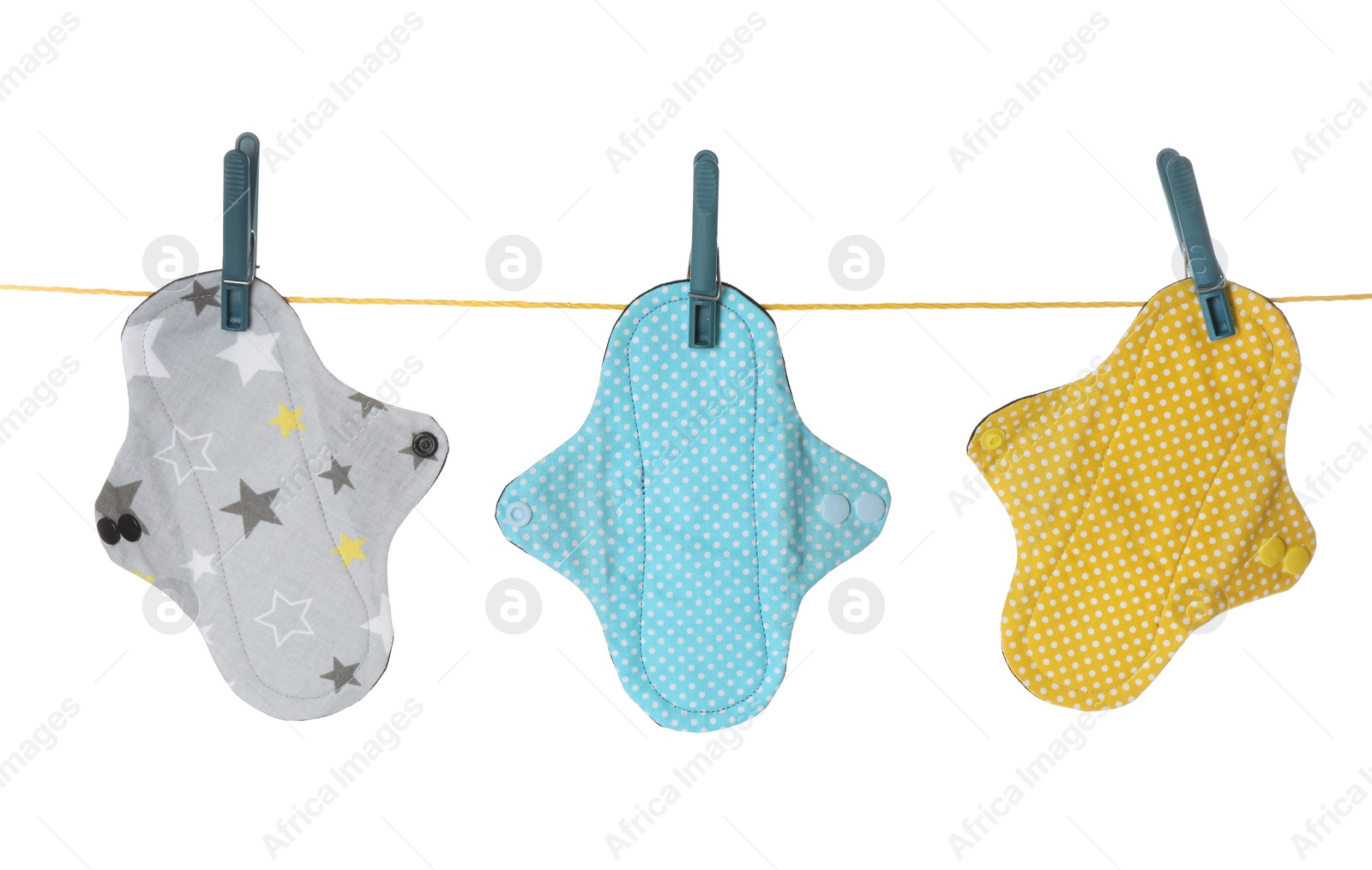 Photo of Many different cloth menstrual pads hanging isolated on white