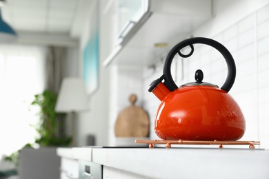 Modern kettle on kitchen counter indoors, space for text