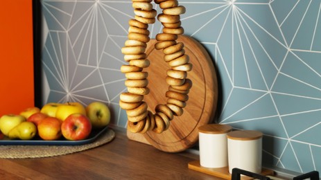 Photo of Bunch of delicious ring shaped Sushki (dry bagels) hanging in kitchen