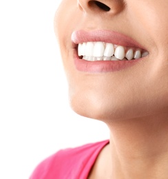 Young woman with healthy teeth on white background, closeup