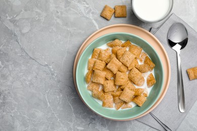 Photo of Bowl with tasty corn pads and milk on light grey marble table, flat lay. Space for text