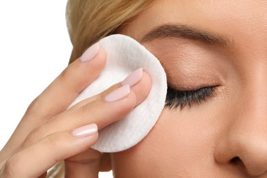 Photo of Woman removing makeup with cotton pad on white background, closeup