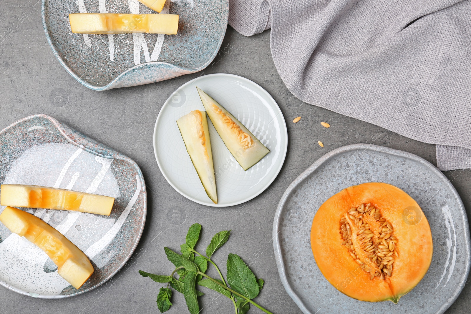 Photo of Flat lay composition with cut fresh tasty melons on table