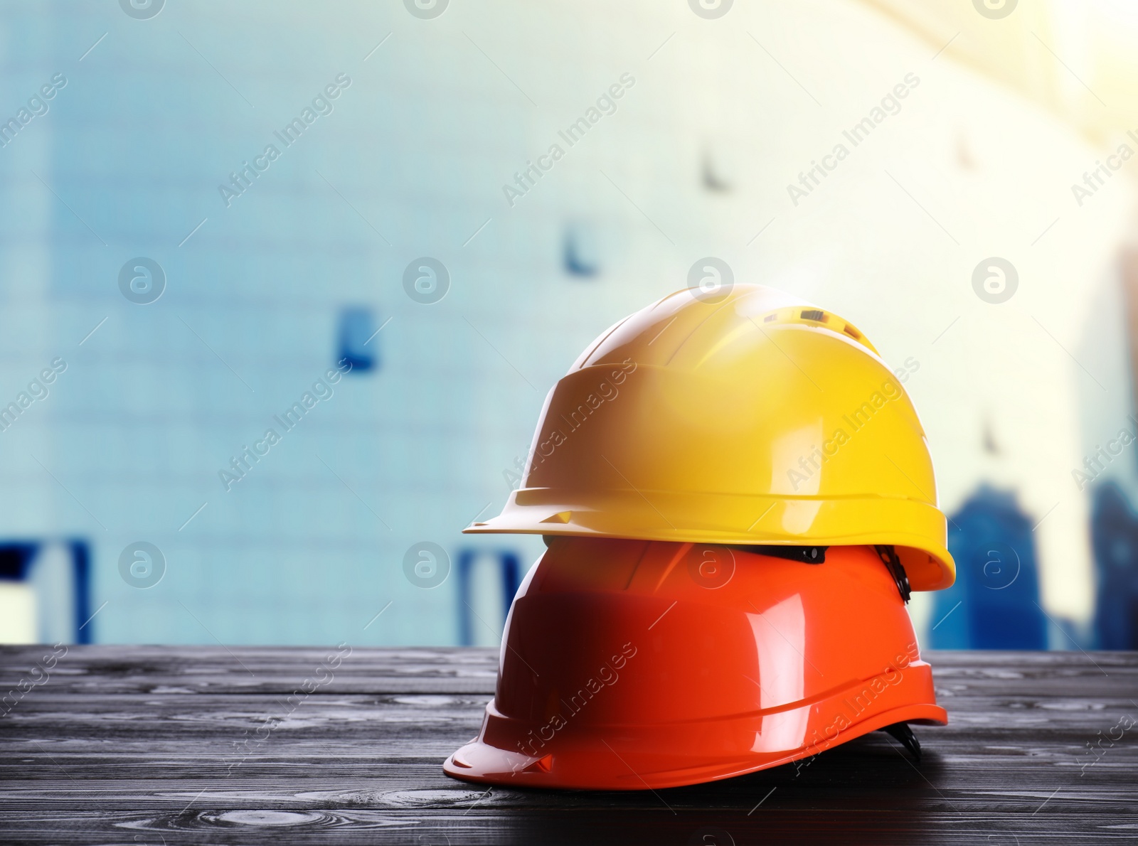 Image of Hard hats on wooden surface at construction site. Space for text 