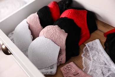 Photo of Drawer with beautiful female lace underwear, closeup