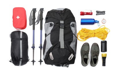 Photo of Pair of trekking poles and camping equipment for tourism on white background, top view