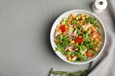 Photo of Delicious fresh chickpea salad served on light grey table, flat lay. Space for text
