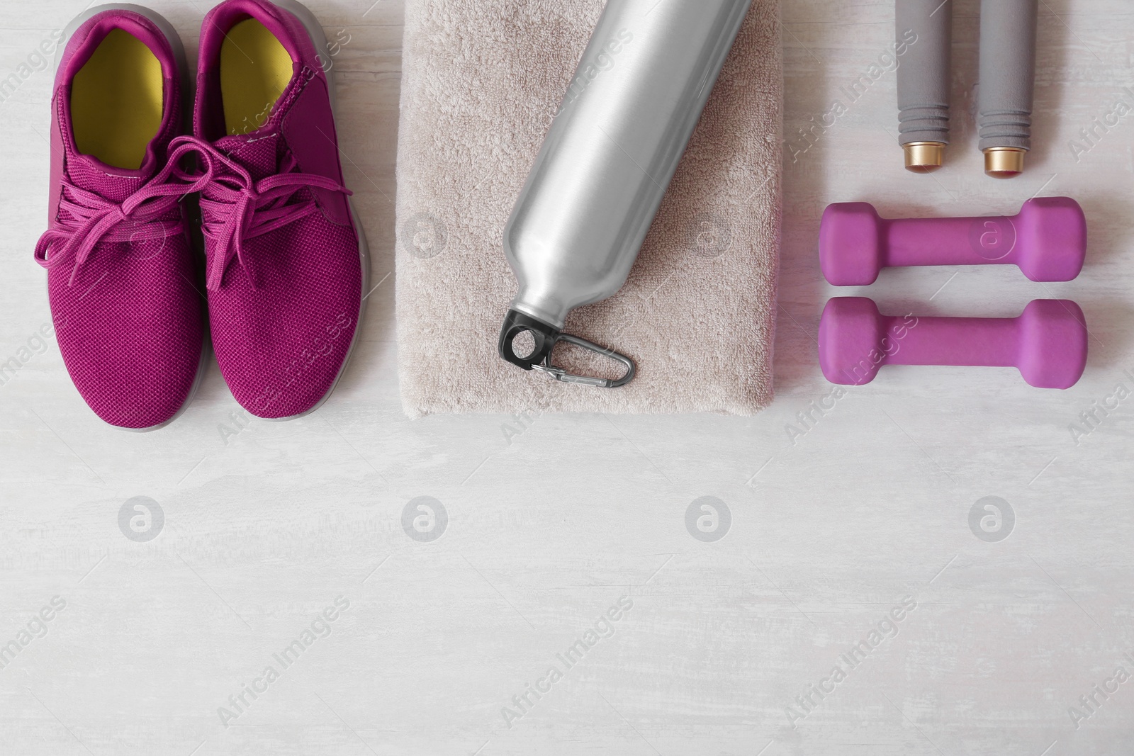 Photo of Flat lay composition with fitness equipment and space for text on gray background