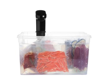 Photo of Sous vide cooker and vacuum packed food products in box isolated on white. Thermal immersion circulator