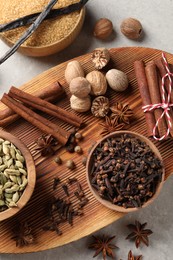 Photo of Different spices on light gray table, top view