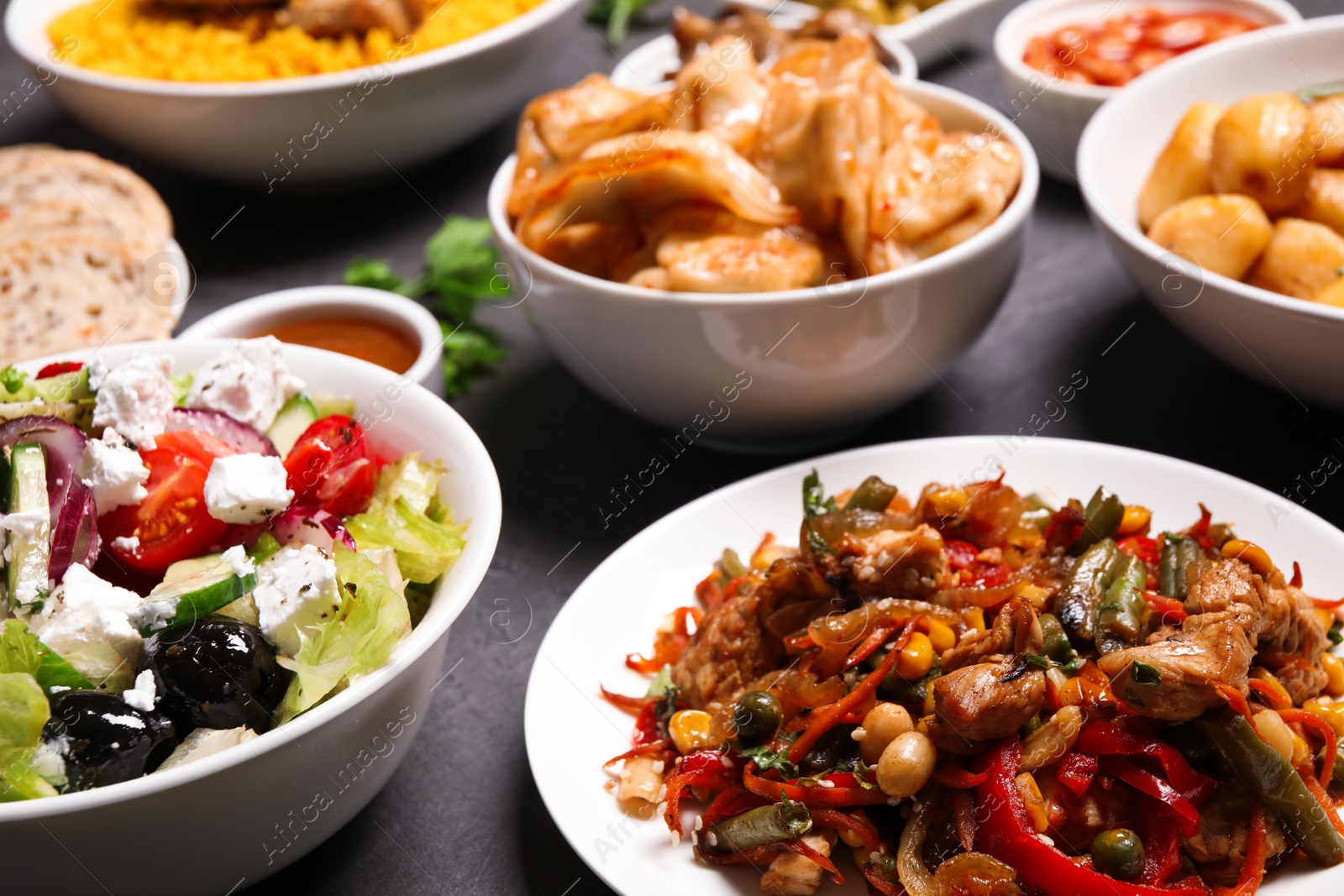 Photo of Buffet service. Many different dishes on grey table