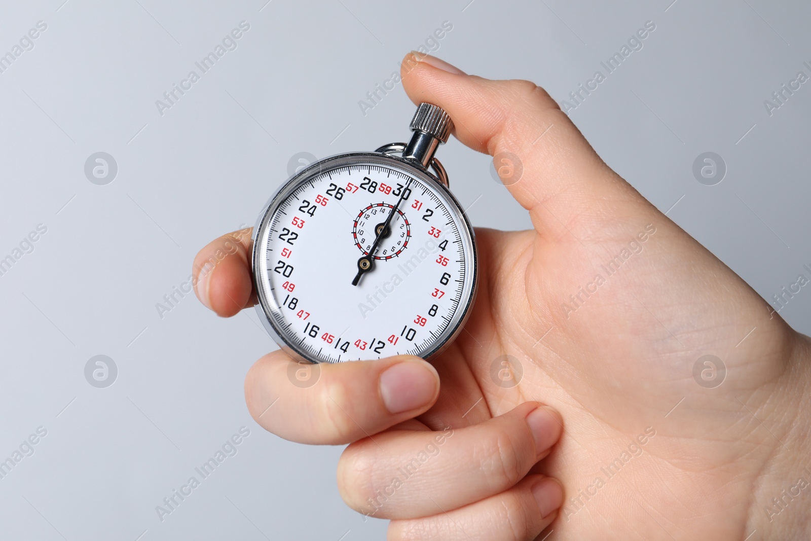 Photo of Woman holding vintage timer on white background, closeup