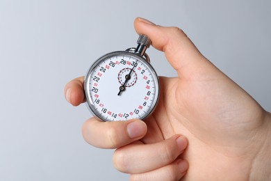 Woman holding vintage timer on white background, closeup