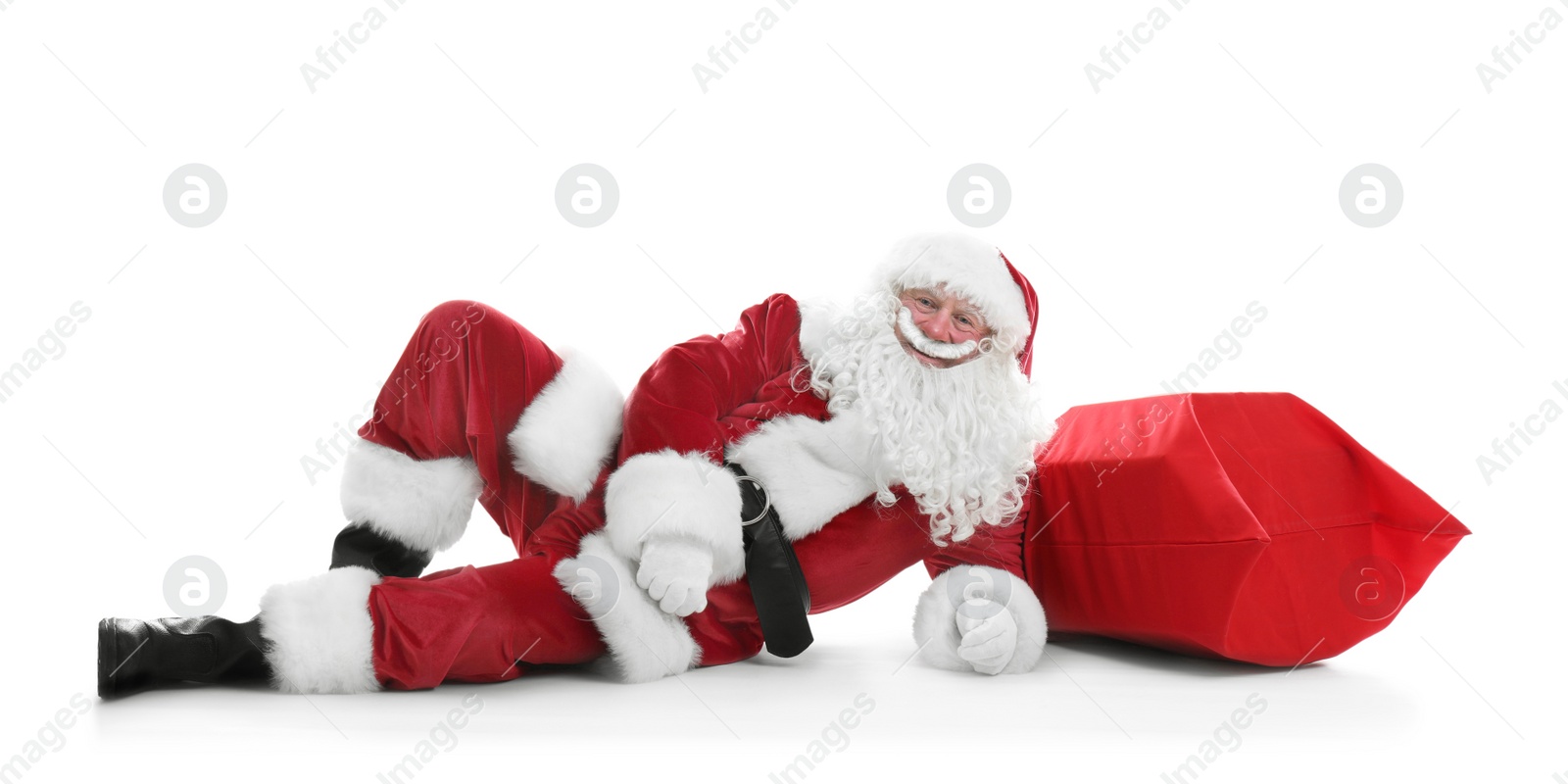 Photo of Authentic Santa Claus with big red bag full of gifts lying on white background