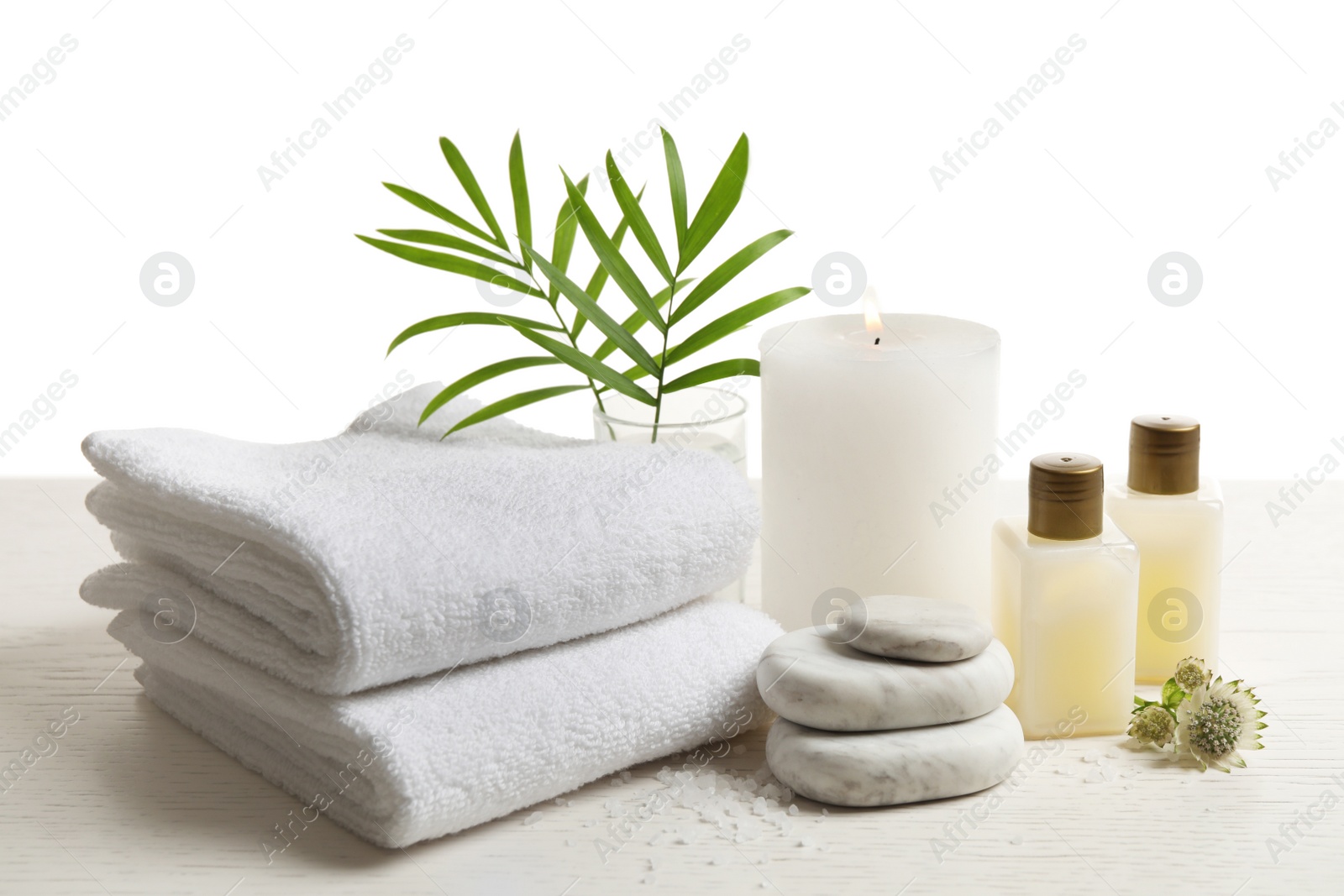 Photo of Composition with spa stones on white wooden table