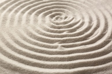 Photo of Beautiful spiral on sand, closeup. Zen garden