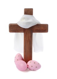 Photo of Wooden cross, cloth and painted Easter eggs on white background