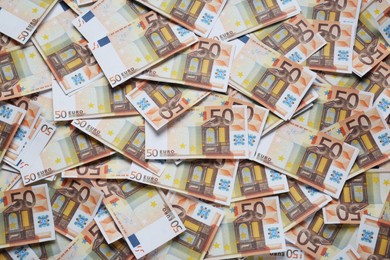 Photo of 50 Euro banknotes as background, top view. Money exchange
