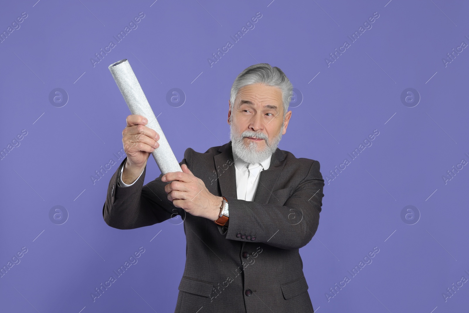 Photo of Man with party popper on purple background