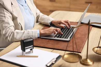 Notary using laptop at workplace in office, closeup