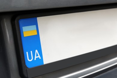 Car with vehicle registration plate, closeup view