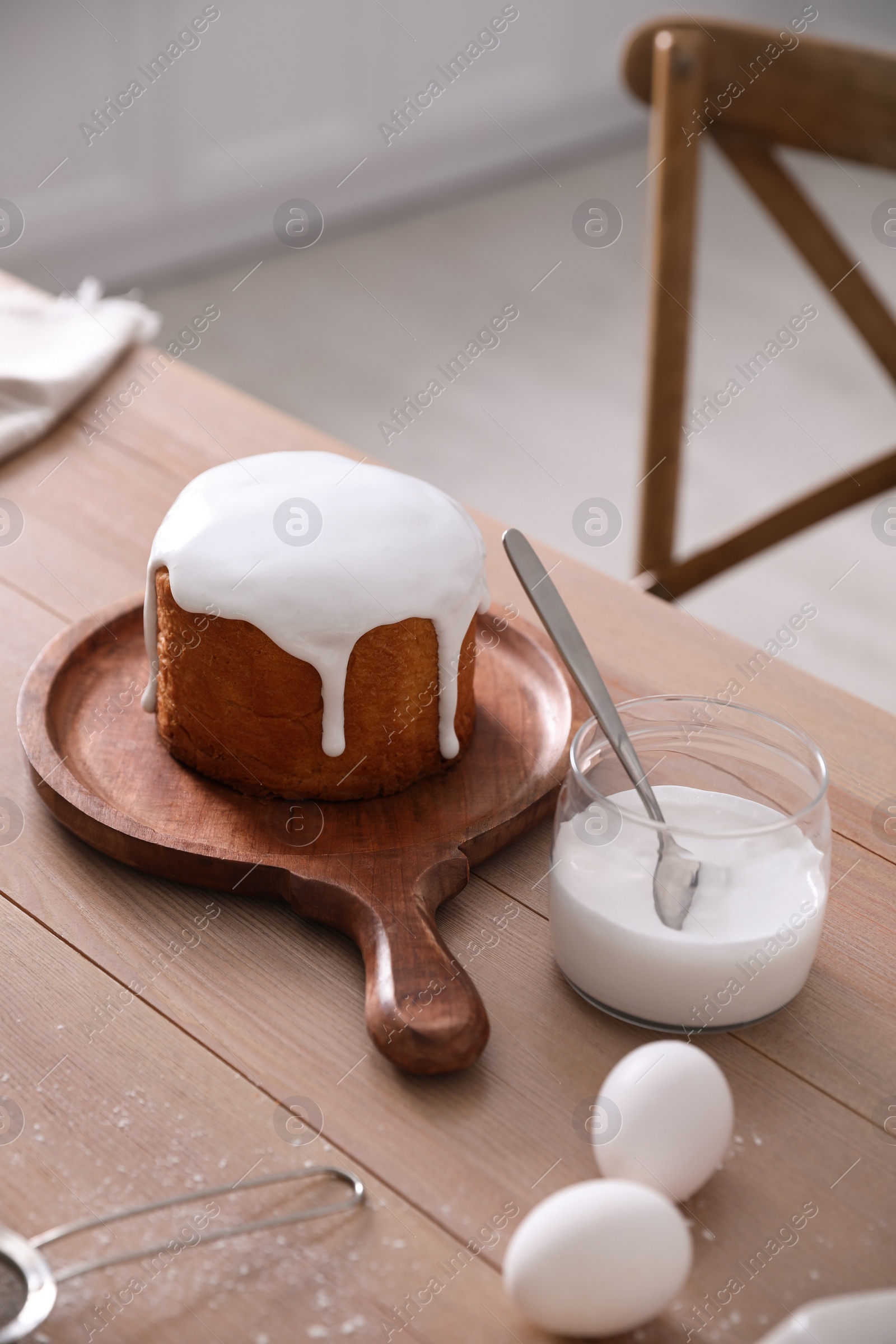 Photo of Traditional Easter cake and ingredients on wooden table indoors