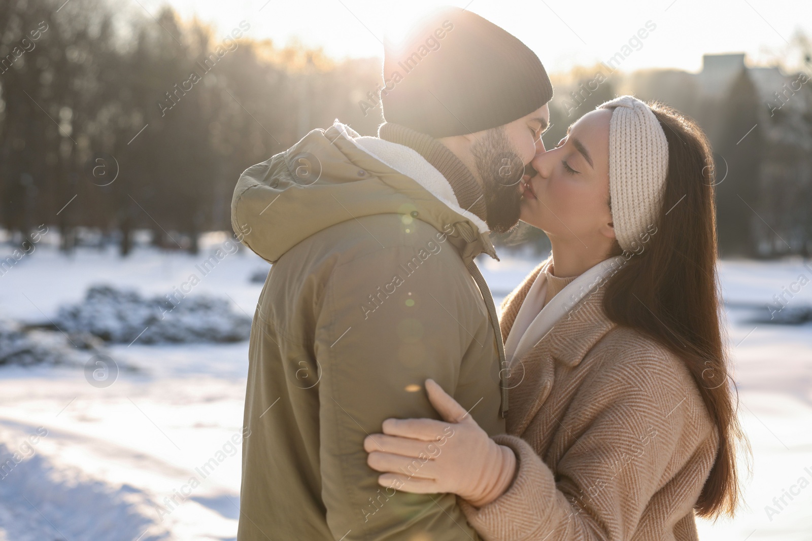 Photo of Beautiful happy couple in snowy park on winter day