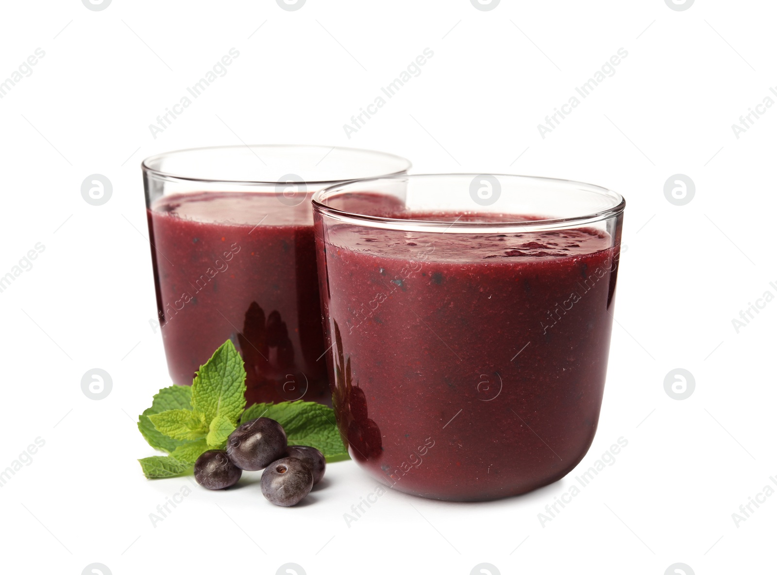 Photo of Glasses with delicious acai smoothie on white background