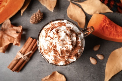 Delicious pumpkin latte on grey table, top view