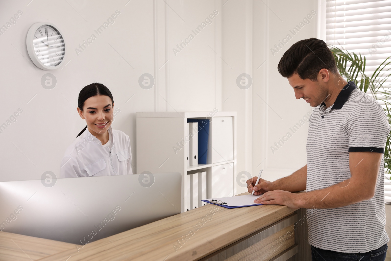 Photo of Nurse and patient at reception in hospital