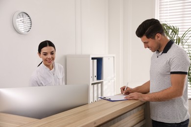 Photo of Nurse and patient at reception in hospital