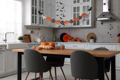 Photo of Stylish kitchen interior with festive decor. Halloween celebration